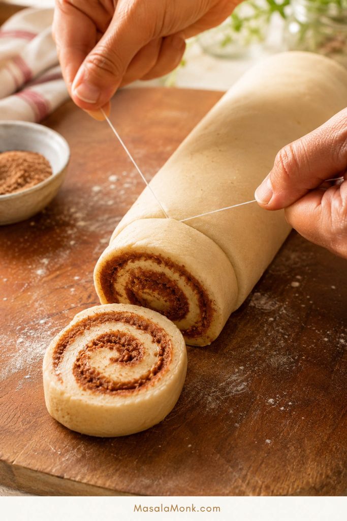 Cutting cinnamon rolls with floss for clean even slices