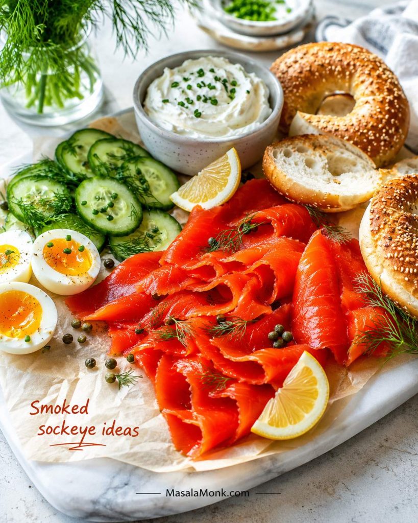 Smoked sockeye salmon served with bagels, cream cheese, cucumber, eggs, lemon, capers, and dill.