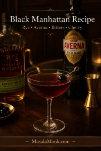 A Black Manhattan cocktail in a chilled coupe glass with a dark brandied cherry garnish, set on a dark bar with rye whiskey and Averna bottles in the background.