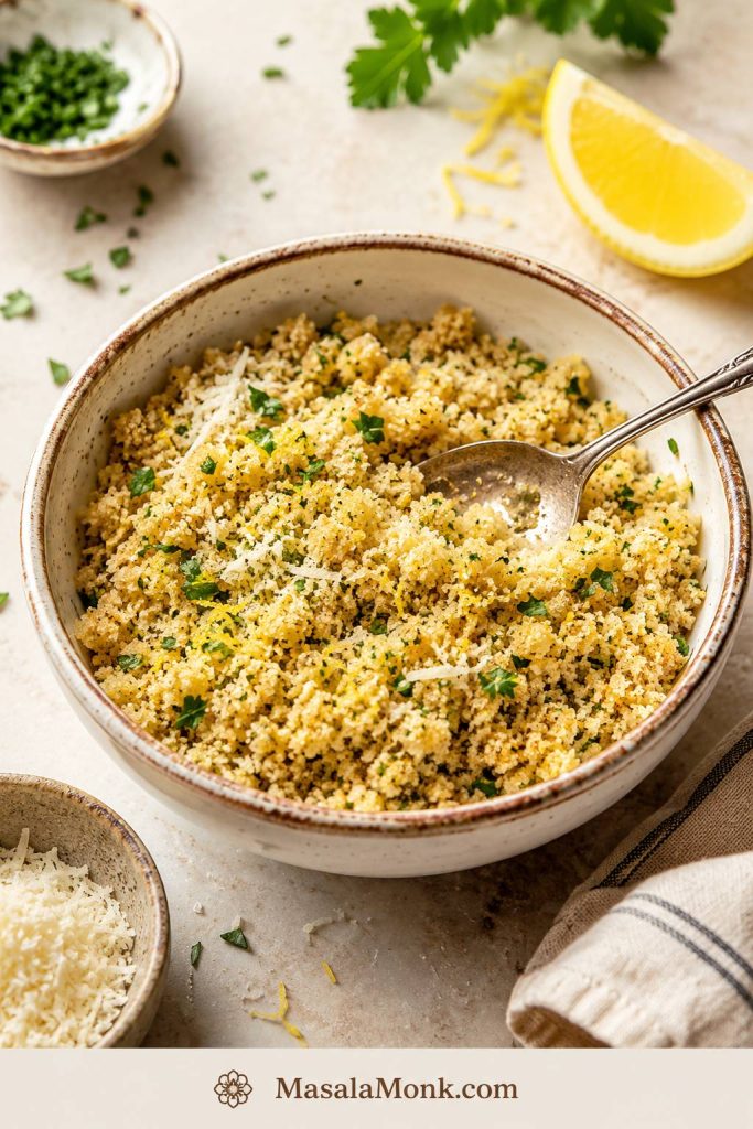 Bowl of buttered panko breadcrumbs with parmesan, herbs, and lemon for topping lobster mac and cheese.