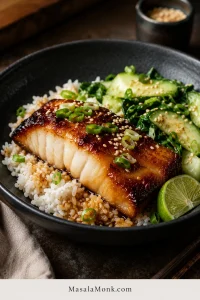 Alt text: Miso black cod served over white rice with cucumber, bok choy, scallions, sesame seeds, and lime.