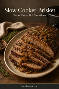 Overlapping slices of tender slow cooker brisket on a stoneware platter, partly covered with glossy brown onion gravy and softened onions.