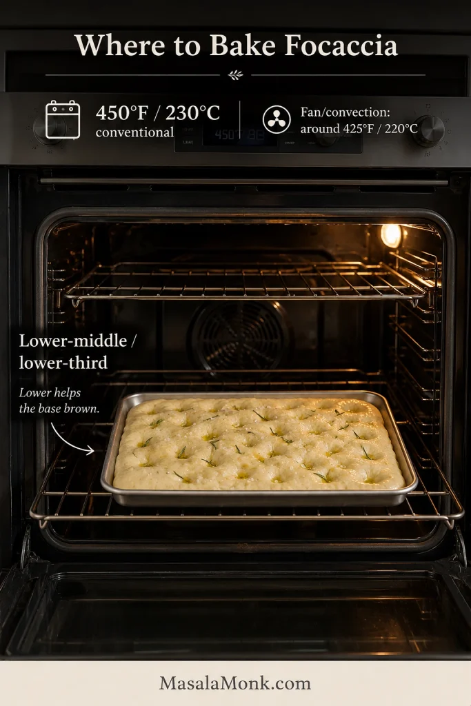 Prepared focaccia in a rectangular pan placed on a lower-middle rack inside a home oven.