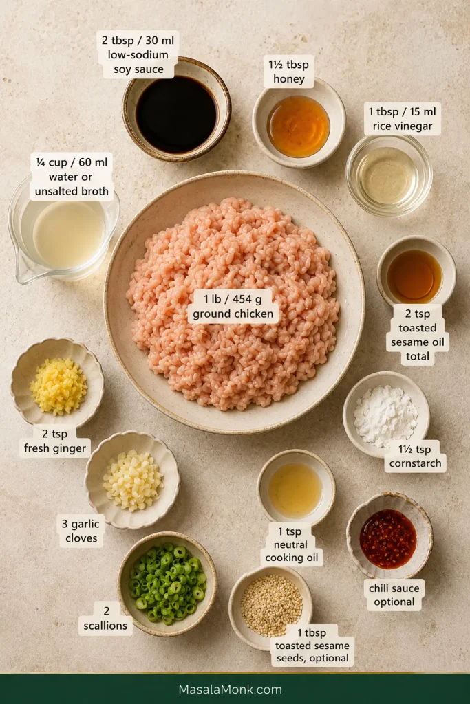 Raw ground chicken surrounded by measured low-sodium soy sauce, honey, rice vinegar, water or broth, toasted sesame oil, cornstarch, ginger, garlic, scallions, sesame seeds and optional chili sauce.