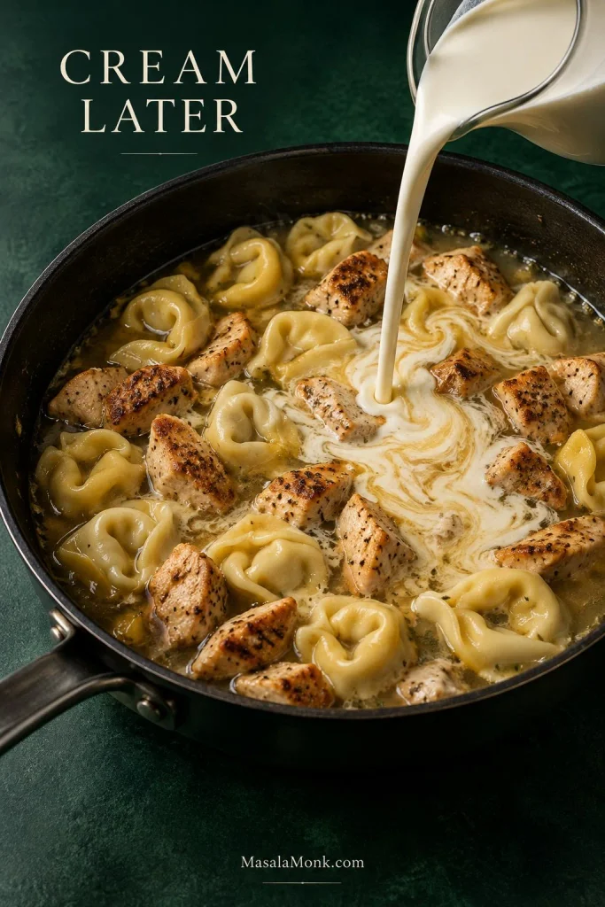 Heavy cream pouring into a skillet with tortellini, broth and browned chicken, creating pale swirls; text reads “Cream Later.”