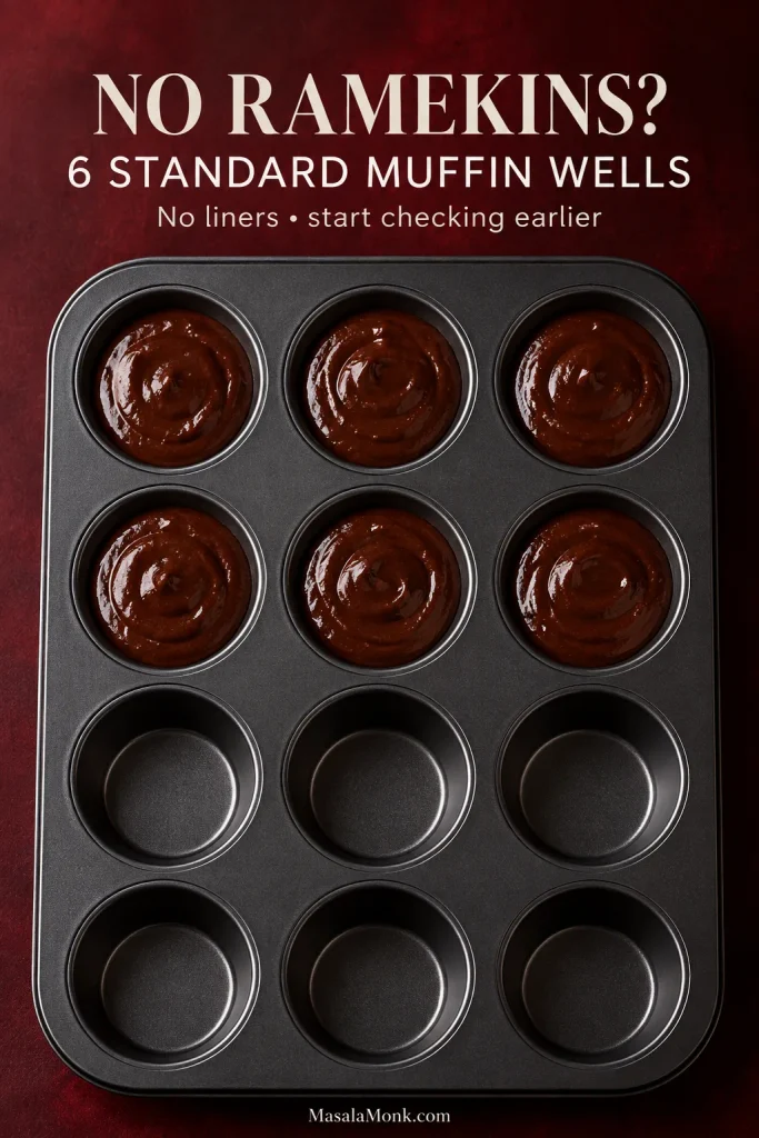 Dark 12-cup muffin pan with chocolate lava cake batter divided evenly among six unlined wells while the remaining six wells are empty.