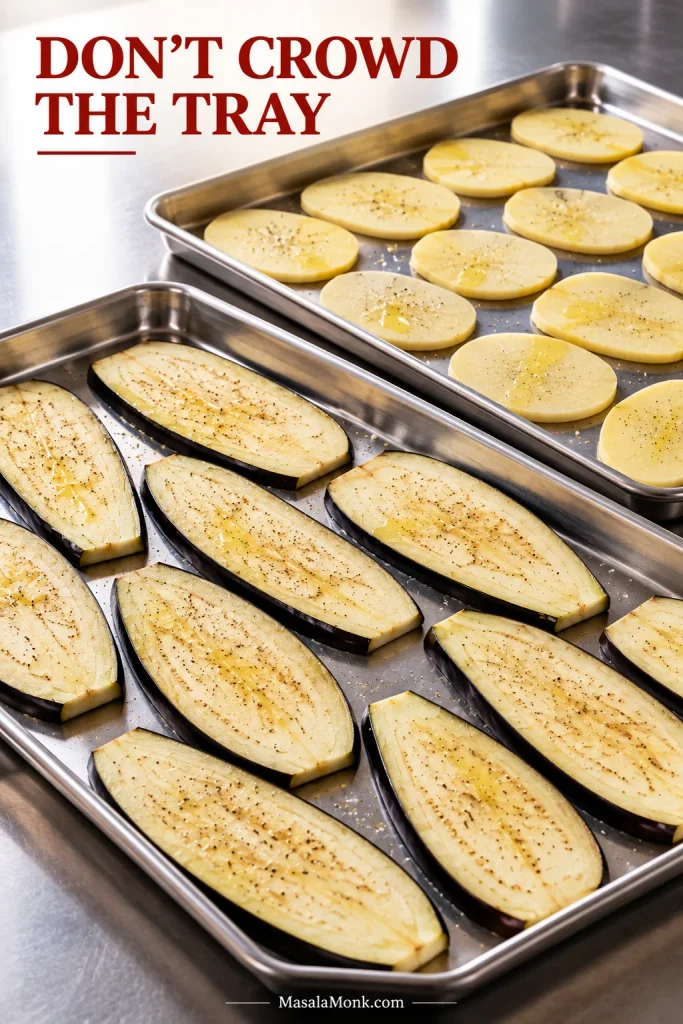 Separate metal trays of lengthwise eggplant slices and thin peeled potato slices arranged in uncrowded single layers.