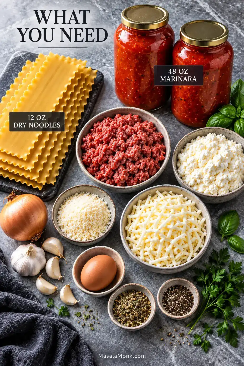 Ingredients for slow cooker lasagna arranged on gray stone, including two jars of marinara, dry lasagna noodles, ground beef, ricotta, mozzarella, Parmesan, onion, garlic, egg, herbs and seasonings.