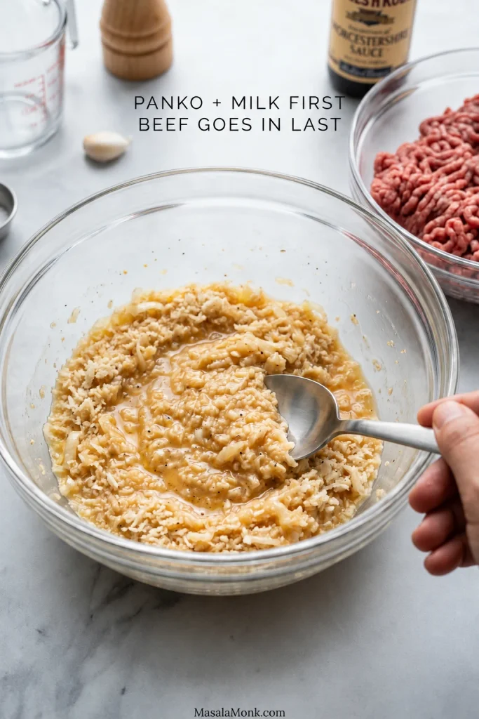 Bowl of milk-soaked panko breadcrumbs beside raw ground beef, with text indicating that the panko and milk are combined before the beef is added.