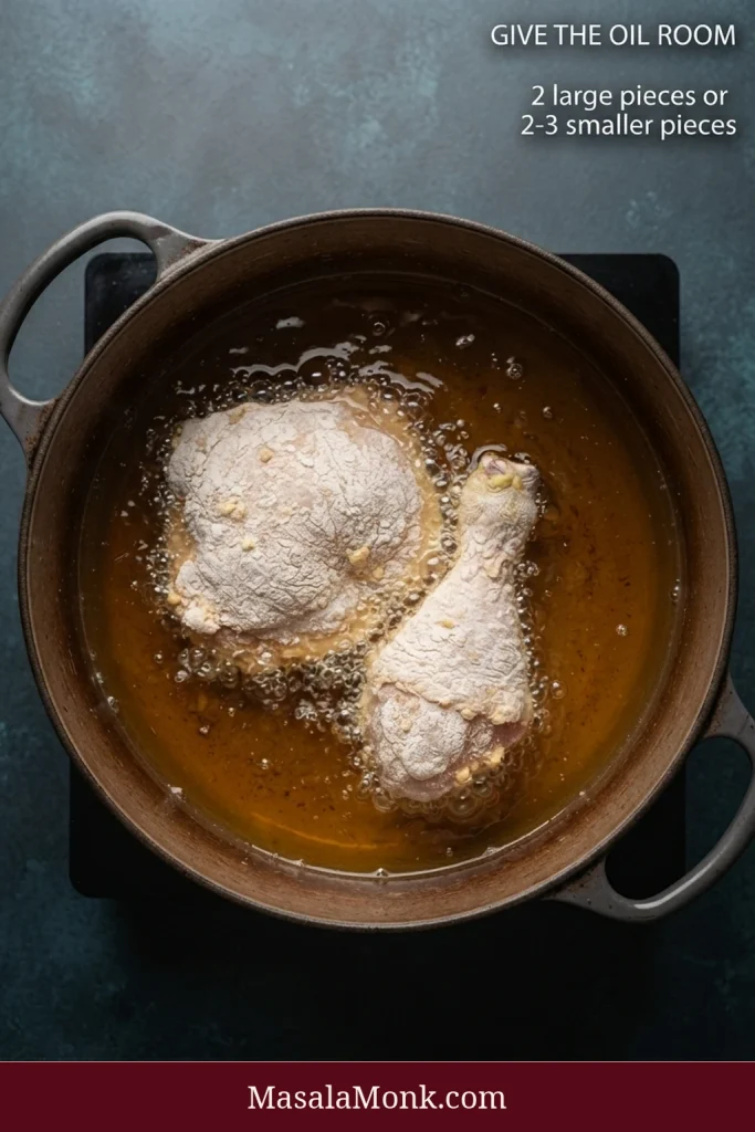 Overhead view of two coated chicken pieces frying with ample open oil around them; text recommends 2 large pieces or 2–3 smaller pieces per batch.