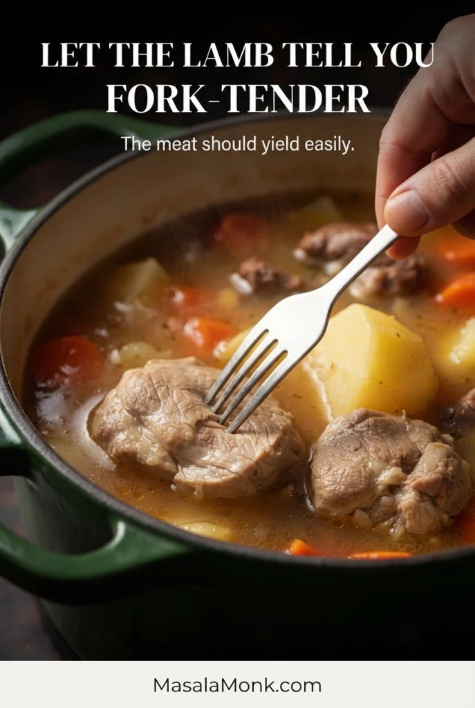Fork pressing into cooked lamb shoulder to check whether the meat yields easily and begins to separate.