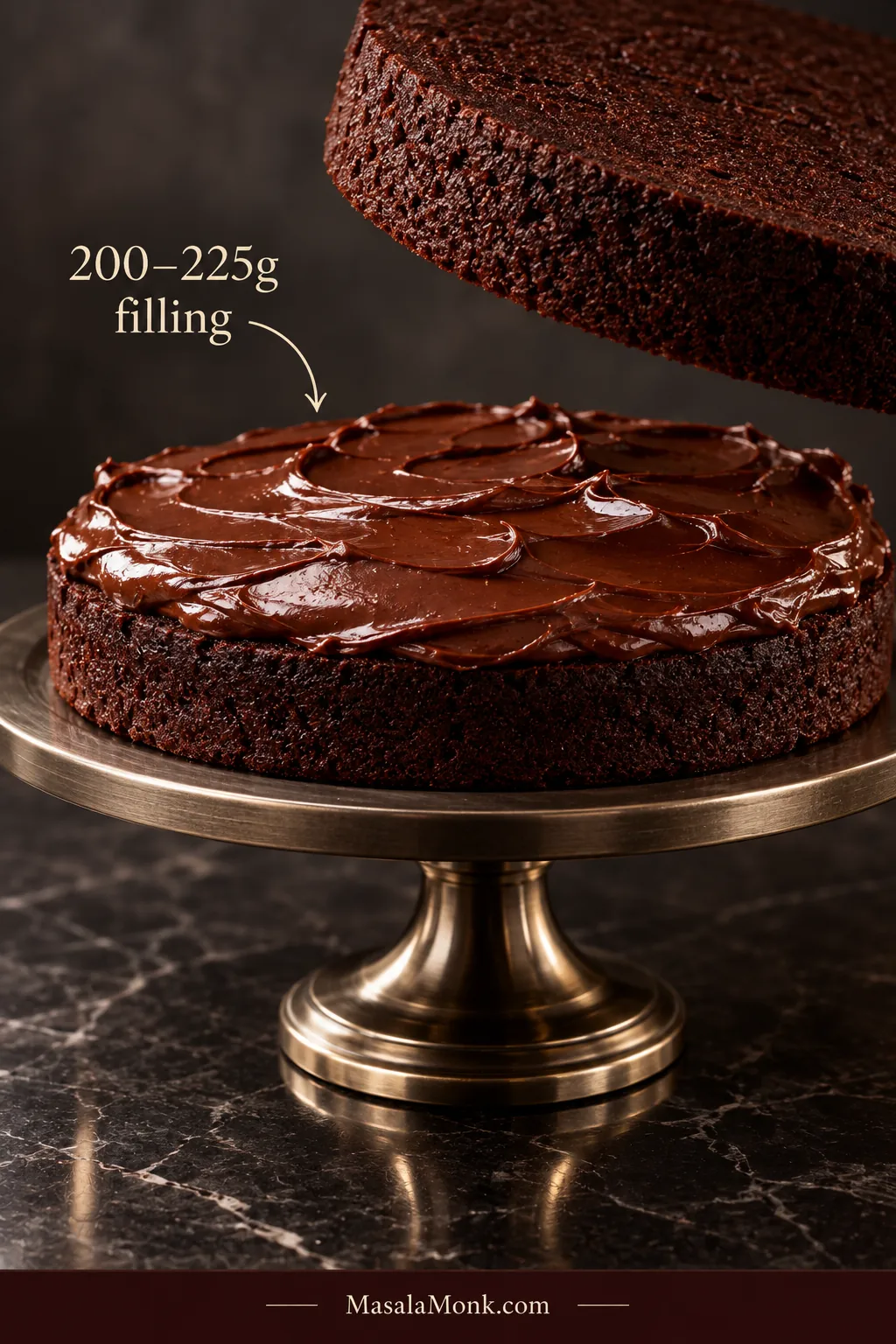 Dark chocolate cake layer spread evenly with glossy ganache while a second layer is positioned above it; overlay reads “200–225g filling.”