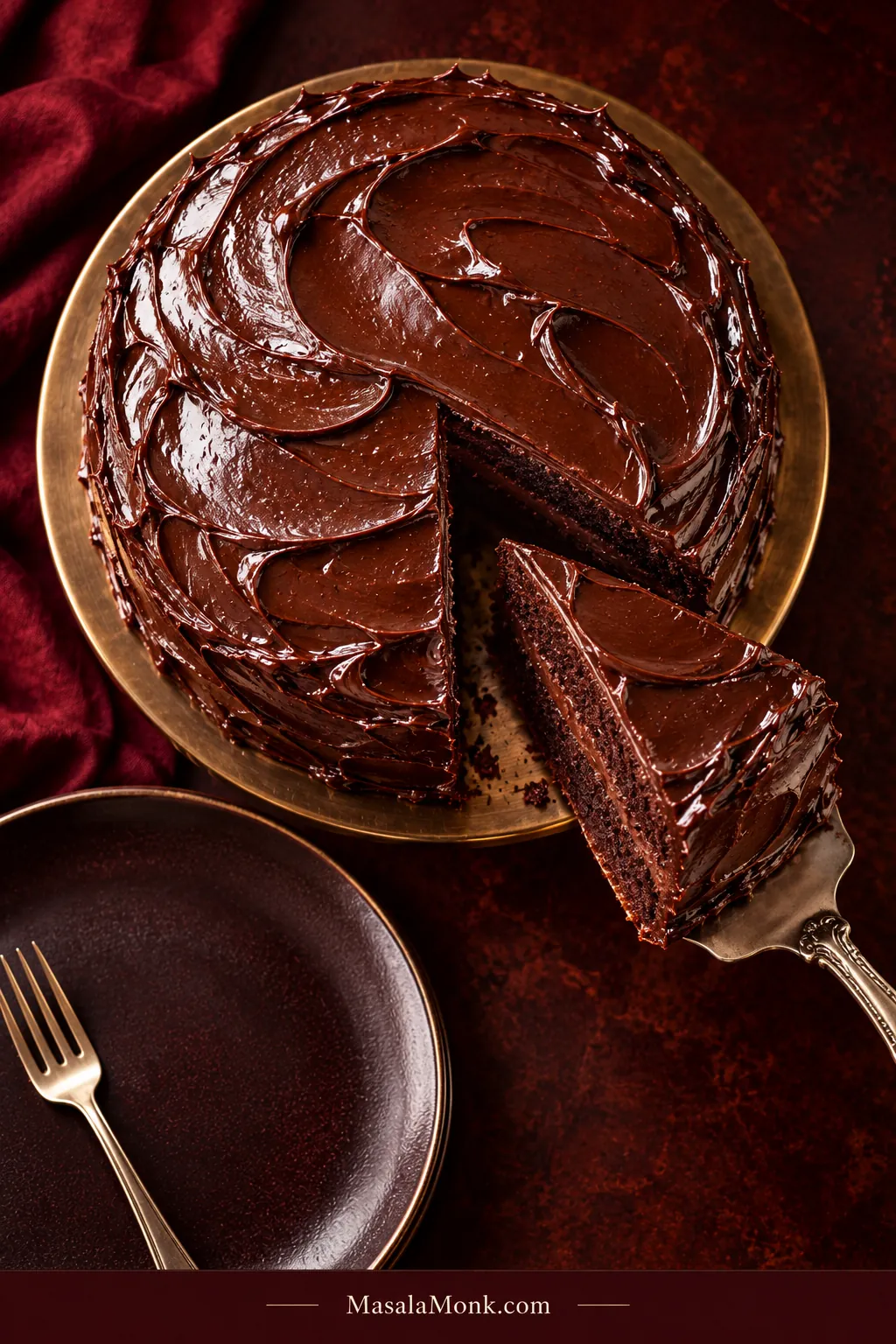 Overhead view of a two-layer Matilda chocolate cake with one wedge removed and lifted on a cake server beside a plate and fork.