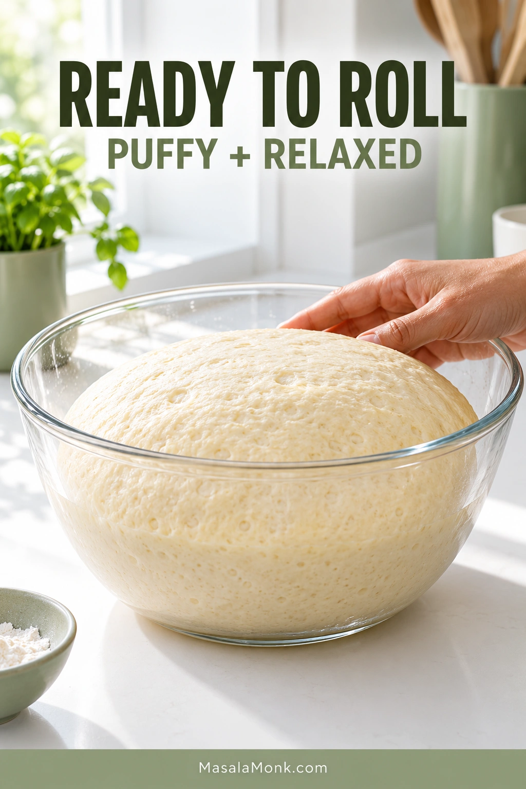 Proofed beignet dough with a gently domed, puffy surface in a clear glass bowl while a hand rests lightly beside it. Text reads “Ready to Roll” and “Puffy + Relaxed.”